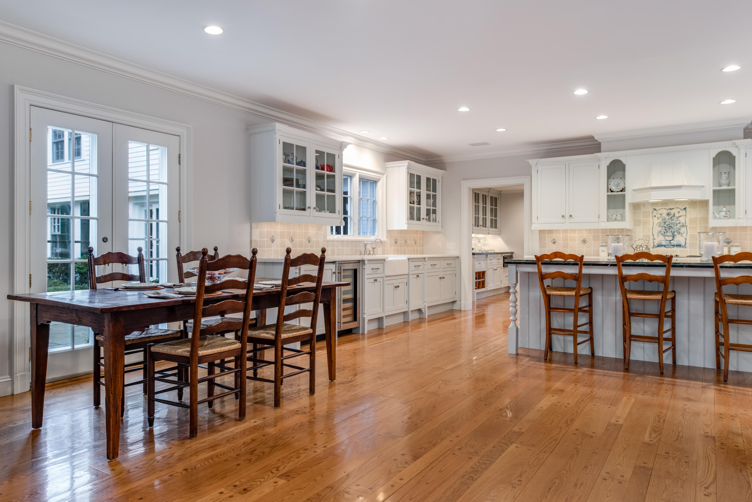 41 St Nicholas Road Darien, CT 06820 - Photo 13 of 39 a open dining hall with stainless steel appliances granite countertop a stove a sink a dining table and chairs with wooden floor