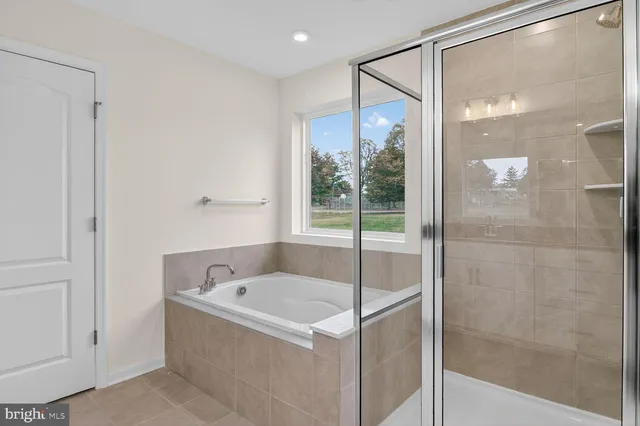 a bathroom with a tub and shower