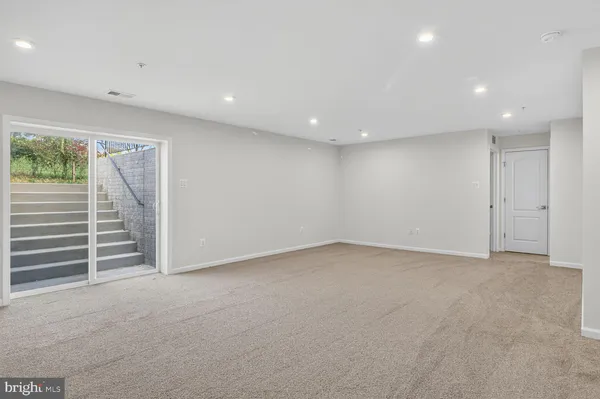 a view of an empty room with stairs