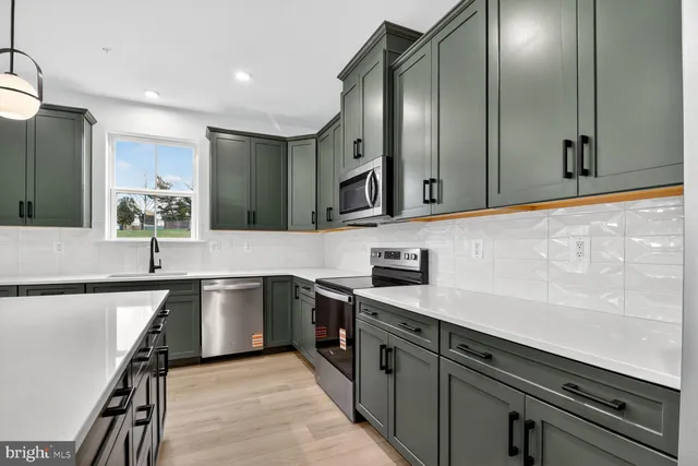 a kitchen with stainless steel appliances granite countertop counter space a sink and cabinets