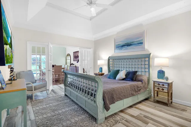 a bedroom with a bed and a chandelier