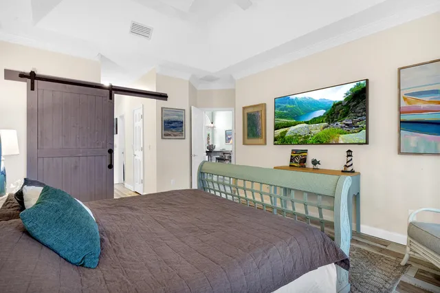 a bedroom with a bed window and a flat screen tv