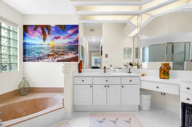 a bathroom with a bathtub sink and mirror