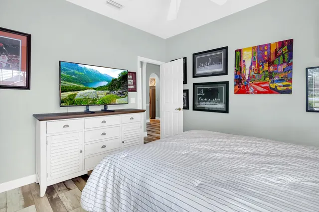 a bedroom with a bed and a flat screen tv