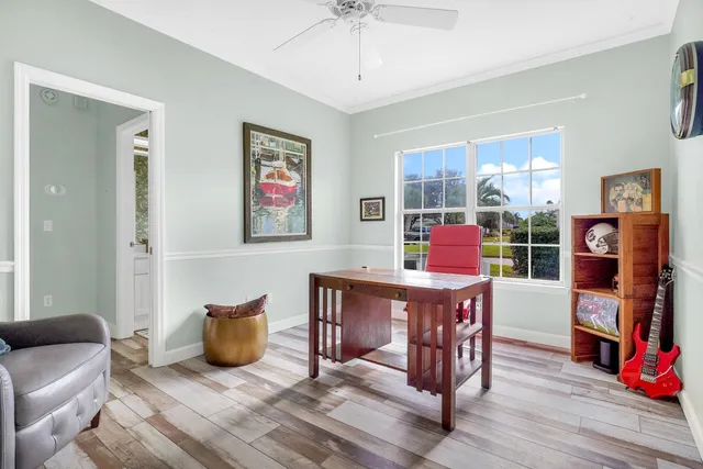 a living room with furniture a wooden floor and a window