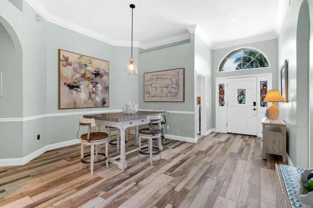 a view of a dining room with furniture wooden floor and a chandelier