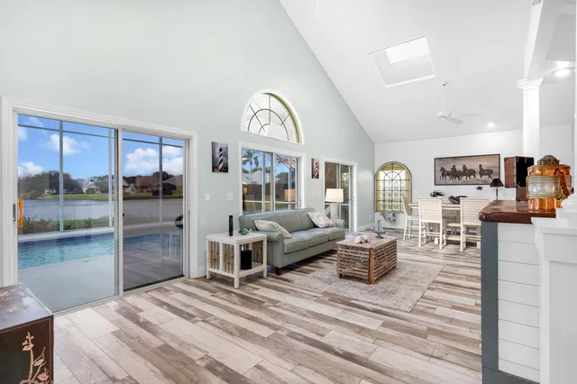 a bedroom with furniture and a floor to ceiling window