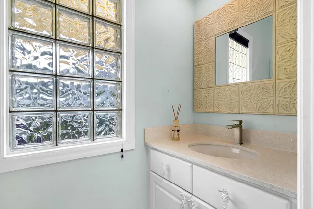 a bathroom with a sink and a window