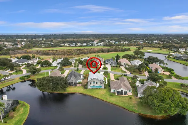 an aerial view of residential houses with outdoor space and swimming pool