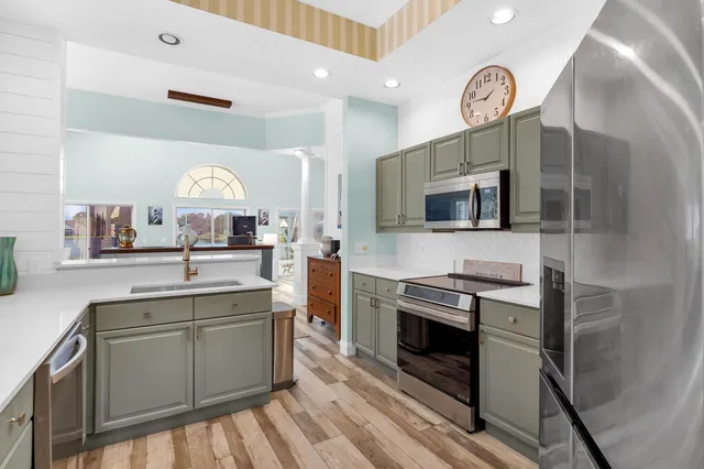 a kitchen with stainless steel appliances a stove microwave and cabinets