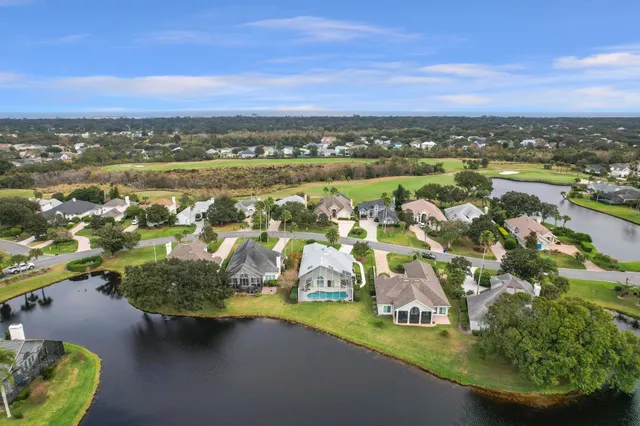 an aerial view of residential houses with outdoor space and swimming pool
