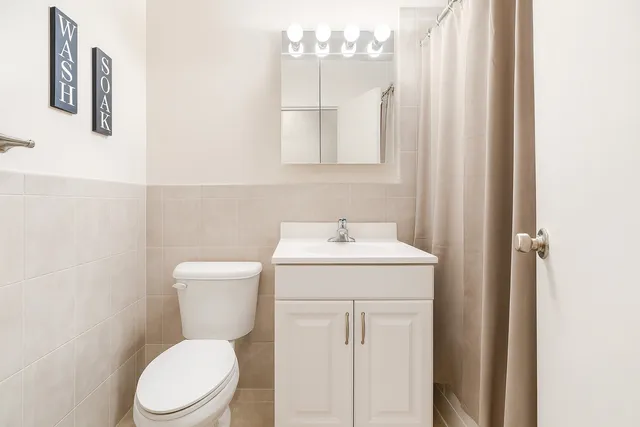 a white toilet sitting next to a bathroom sink