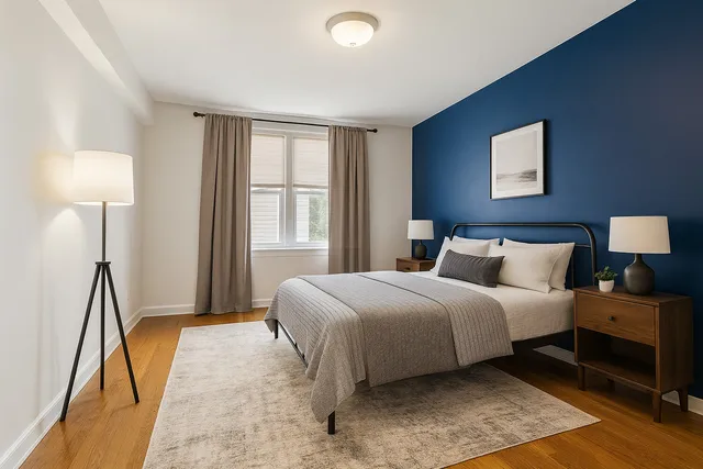 a spacious bedroom with a bed and a lamp