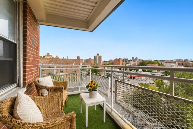 a view of a balcony with two chairs and a table