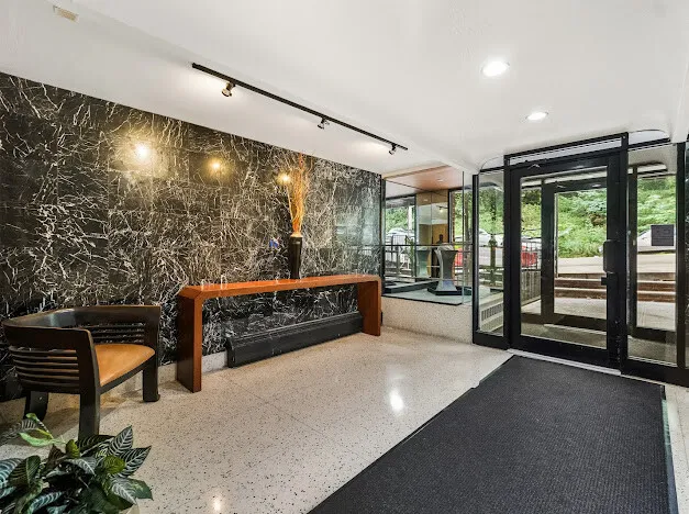 a bedroom with furniture and large windows