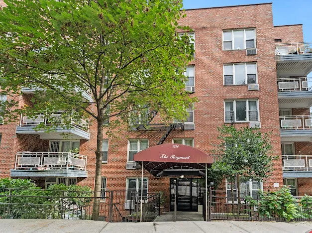 a front view of a building with a yard