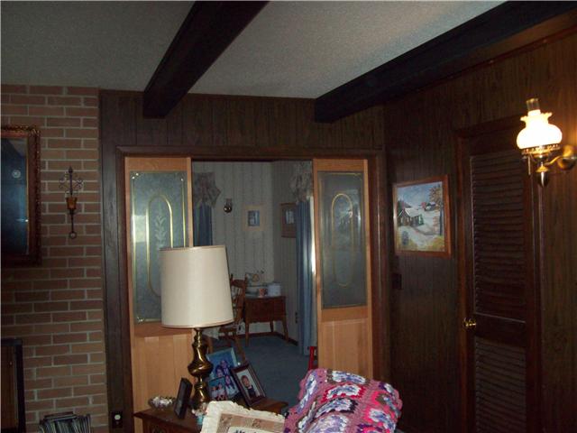 281 Doak Road Manchester, TN 37355 - Photo 10 of 20 Another view of the living room, featuring the wooden beams and opening into dining room.