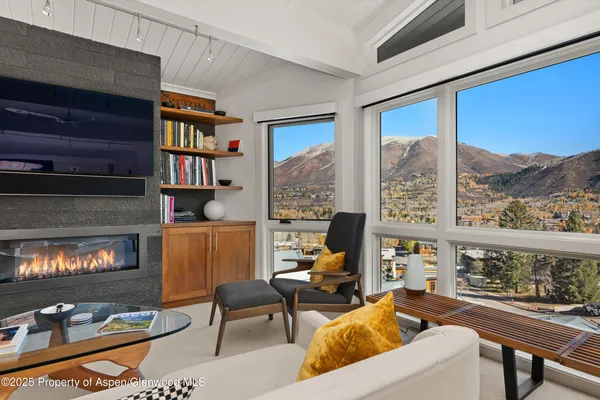 a living room with fireplace furniture and a flat screen tv