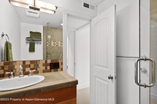 a aerial view of a house with swimming pool and large trees