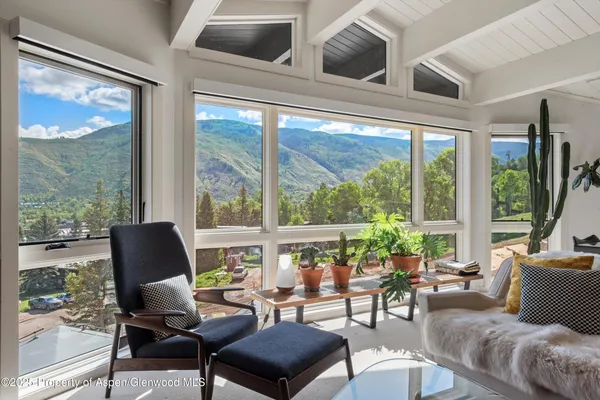 a living room with furniture fireplace and flat screen tv