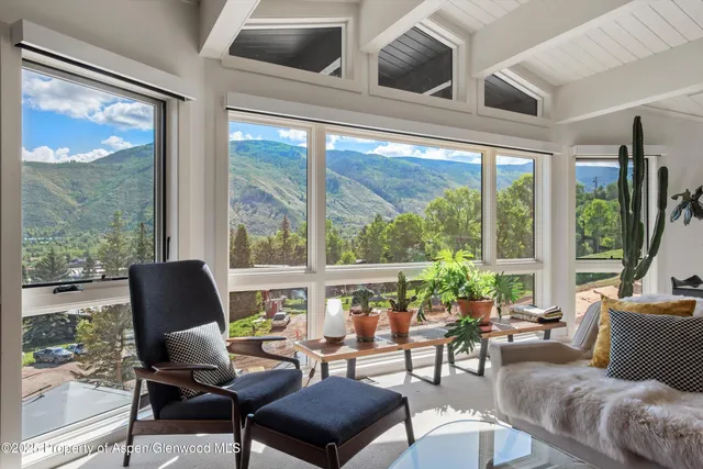 a living room with furniture fireplace and flat screen tv