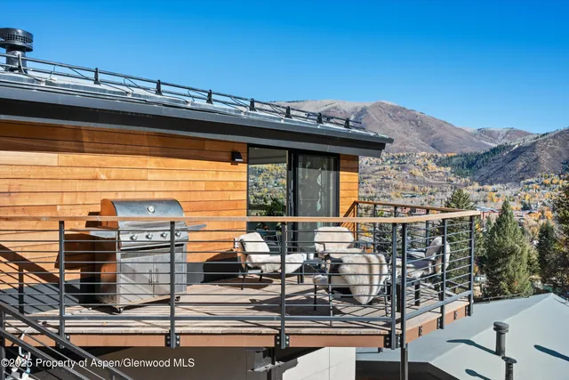 a dining room with furniture a large window and a rug