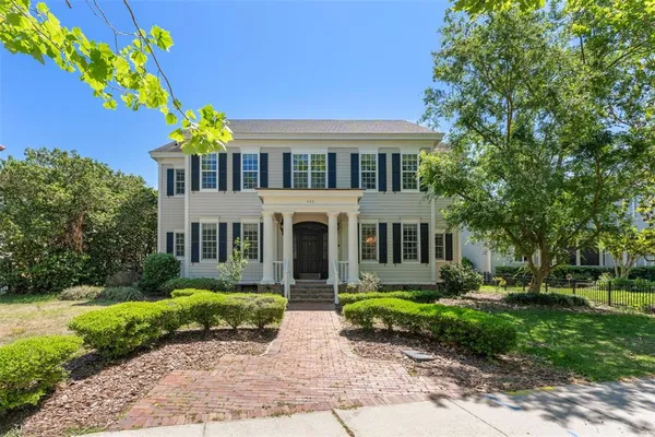 a front view of house with yard and green space