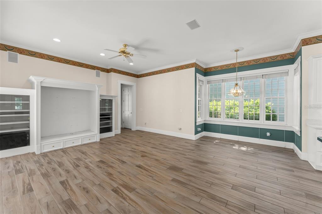 403 Water Street Celebration, FL 34747 - Photo 31 of 86 an empty room with wooden floor cabinet and windows