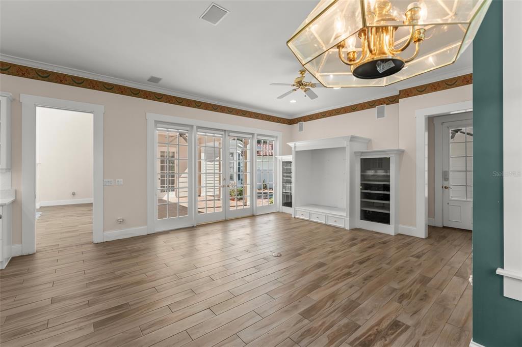 403 Water Street Celebration, FL 34747 - Photo 32 of 86 a view of an empty room with wooden floor and a window