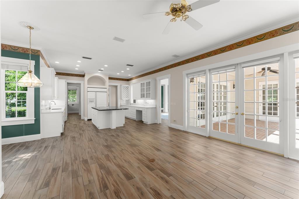 403 Water Street Celebration, FL 34747 - Photo 33 of 86 a open kitchen with white cabinets and wooden floor