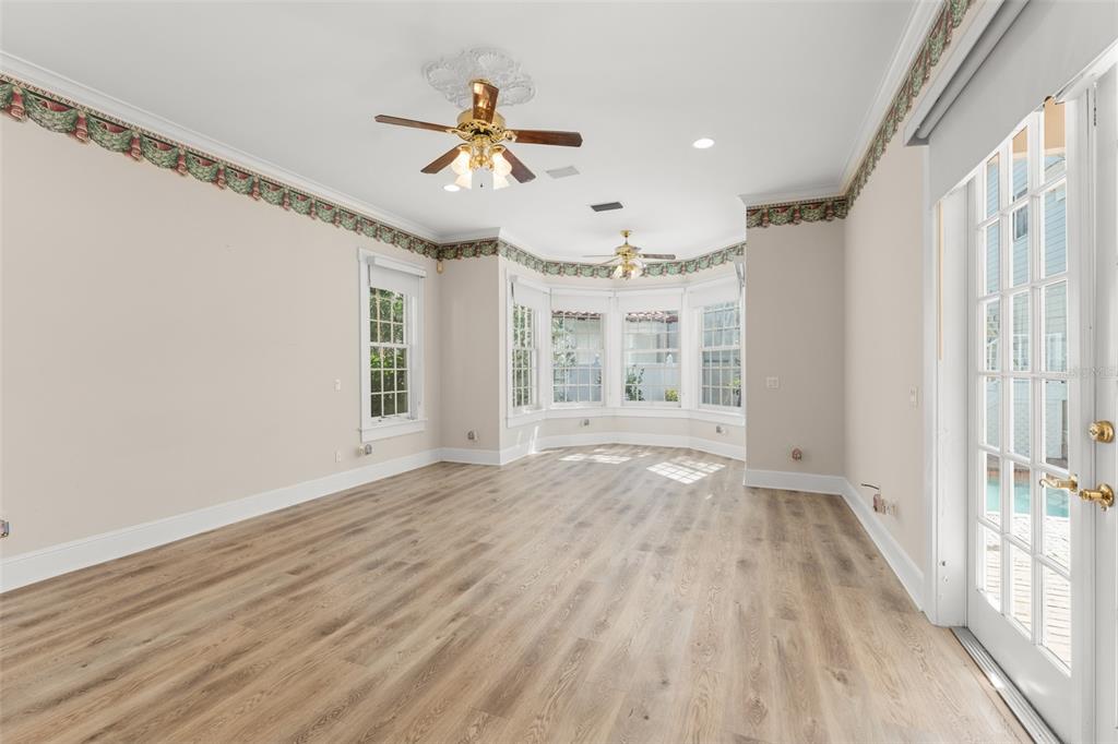 403 Water Street Celebration, FL 34747 - Photo 39 of 86 a view of an empty room with a window and wooden floor