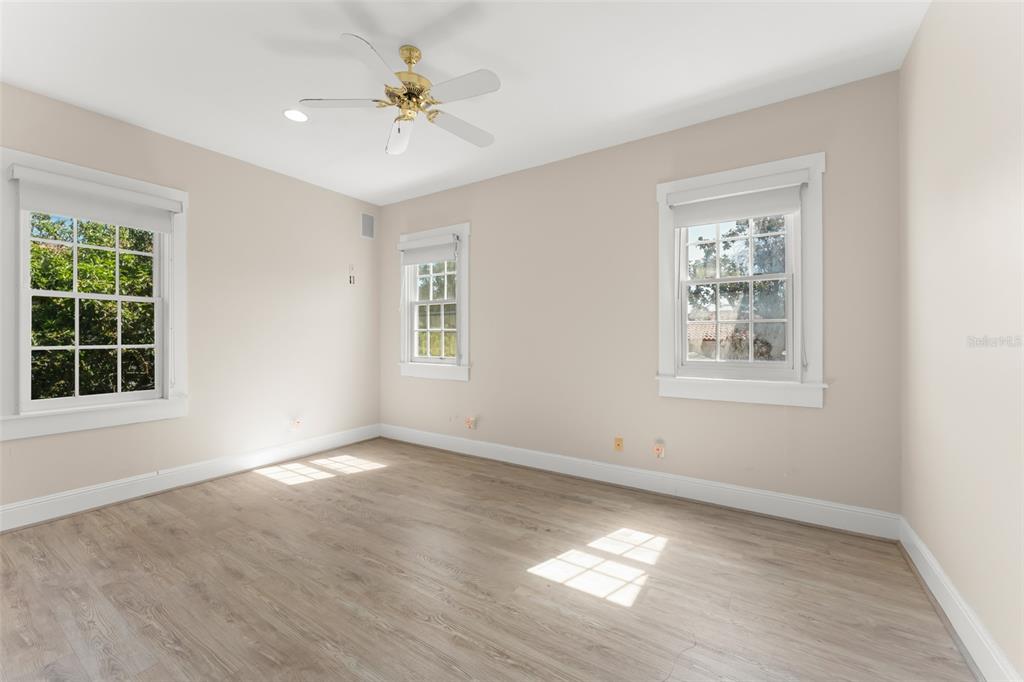 403 Water Street Celebration, FL 34747 - Photo 49 of 86 an empty room with windows and ceiling fan