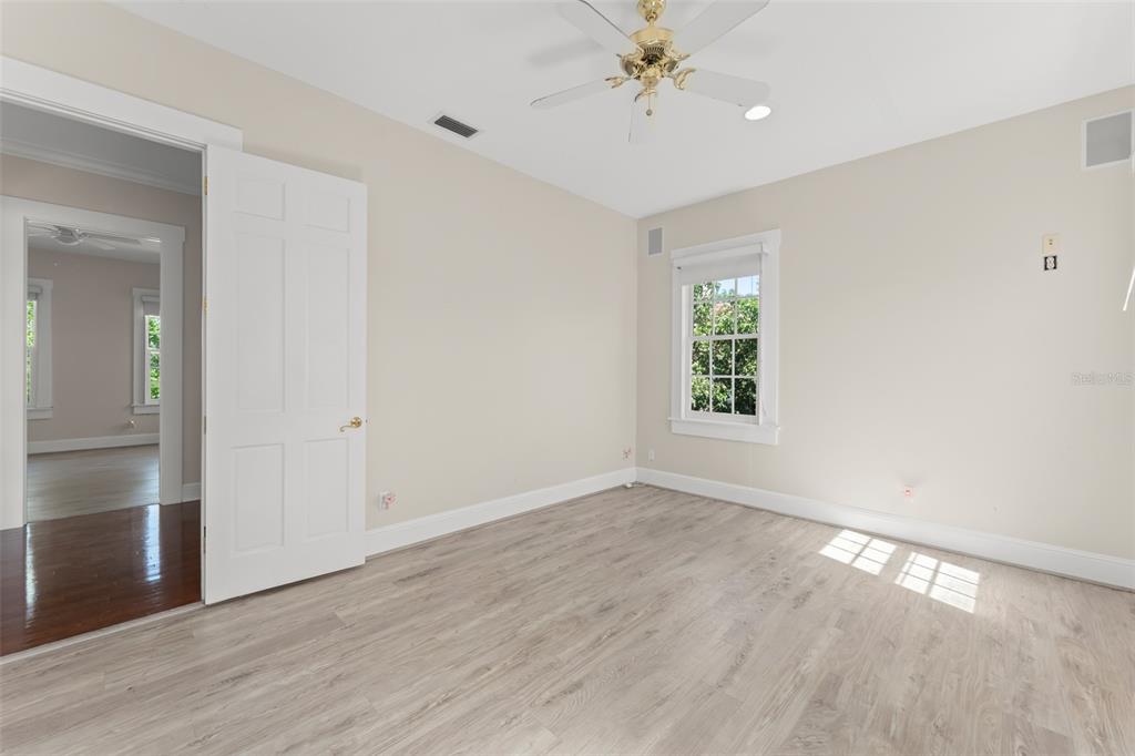 403 Water Street Celebration, FL 34747 - Photo 50 of 86 a view of an empty room with a window and wooden floor
