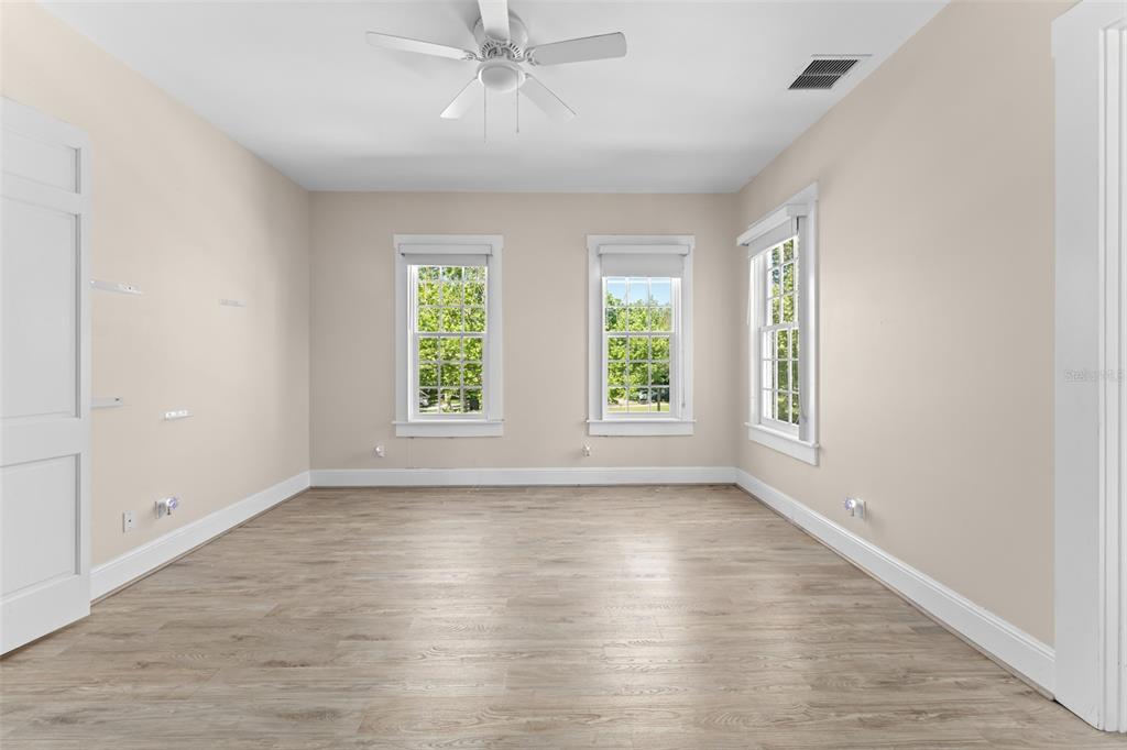 403 Water Street Celebration, FL 34747 - Photo 51 of 86 a view of an empty room with wooden floor and a window