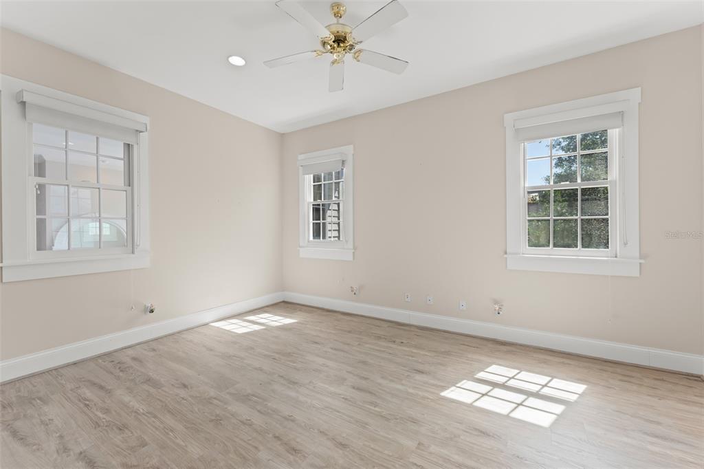 403 Water Street Celebration, FL 34747 - Photo 58 of 86 a view of an empty room with a window and wooden floor