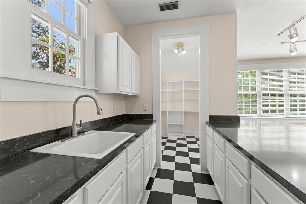 403 Water Street Celebration, FL 34747 - Photo 76 of 86 a kitchen with granite countertop a sink and a stove top oven
