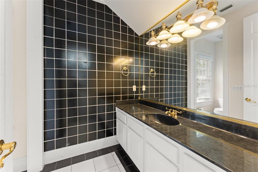 403 Water Street Celebration, FL 34747 - Photo 78 of 86 a bathroom with a double vanity sink a mirror and a shower