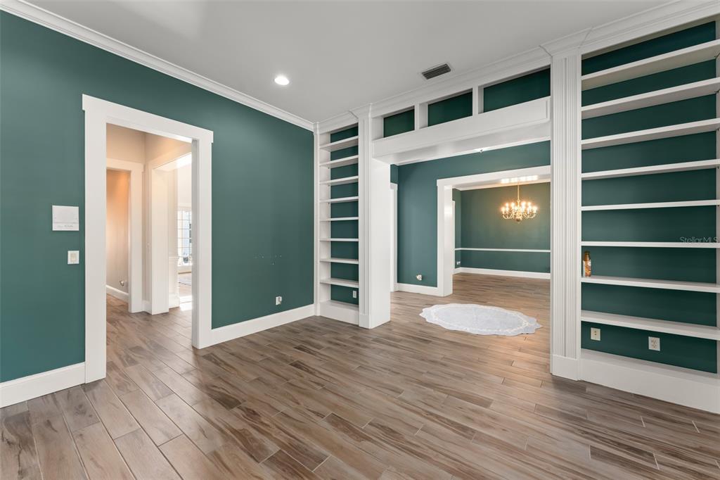 403 Water Street Celebration, FL 34747 - Photo 10 of 86 a view of empty room with wooden floor and fireplace