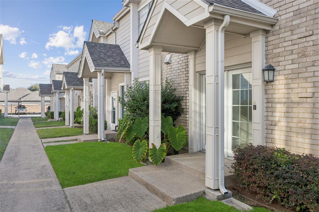 5881 Preston View Boulevard, Unit 131 Dallas, TX 75240 - Photo 1 of 1 a front view of a house with a yard and potted plants