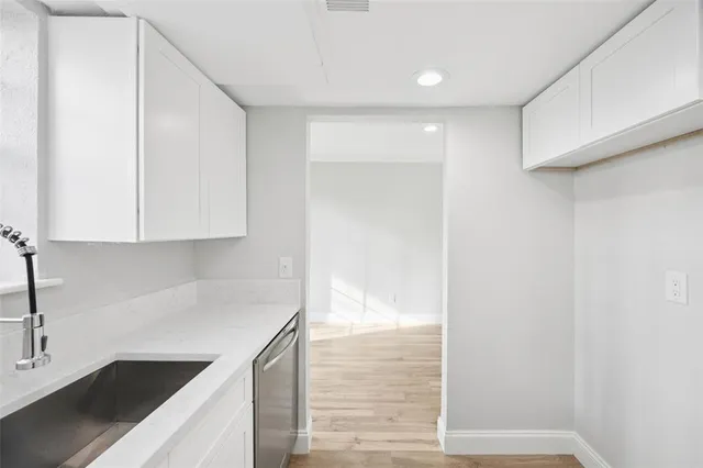 a kitchen with a sink and cabinets