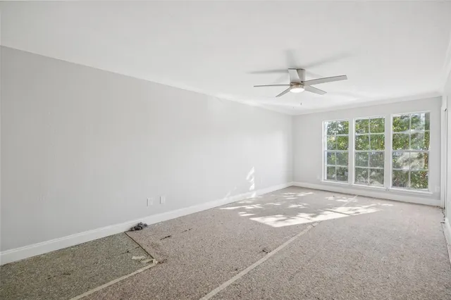 an empty room with a empty space and windows