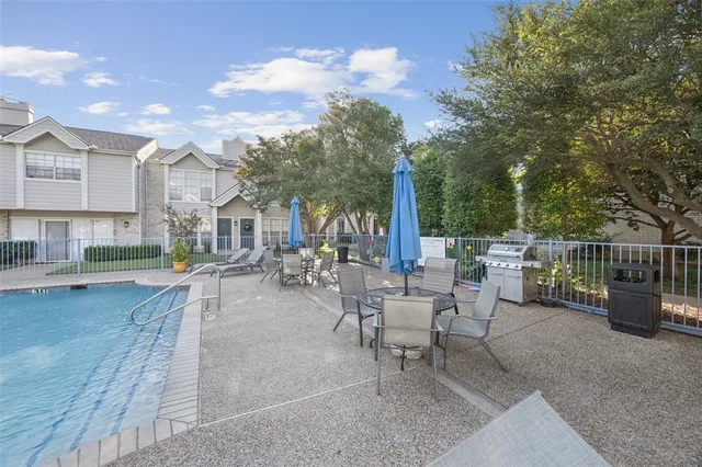 a view of a patio with swimming pool and sitting area