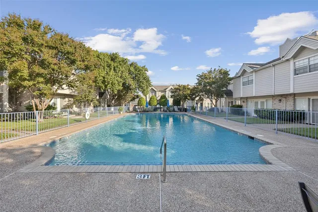 a swimming pool with outdoor seating and yard