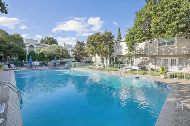 a view of swimming pool and trees in the background