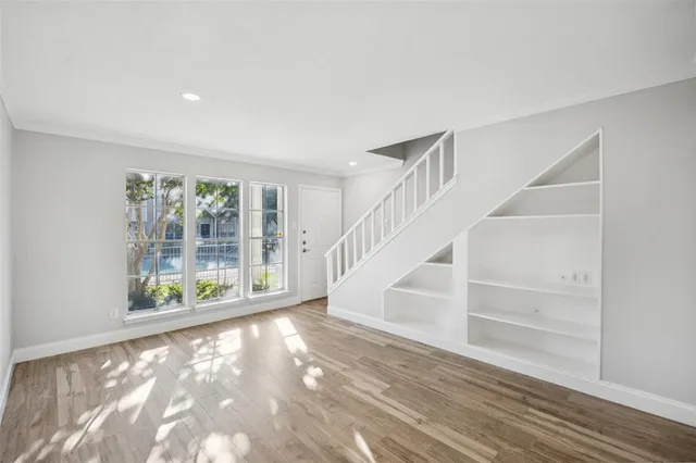 a view of an entryway with wooden floor
