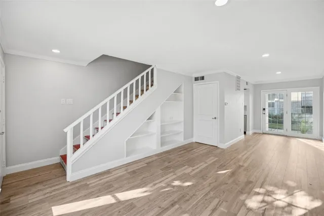 a view of an entryway with wooden floor