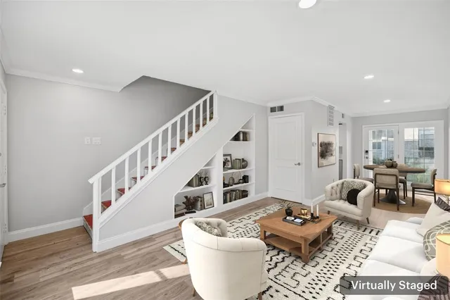 a living room with furniture and wooden floor