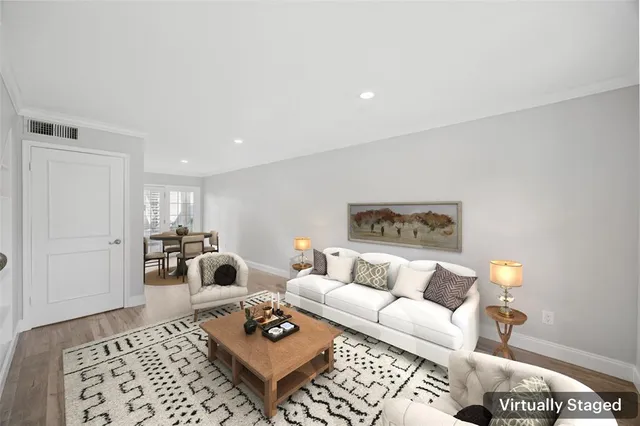 a living room with furniture a rug and a table