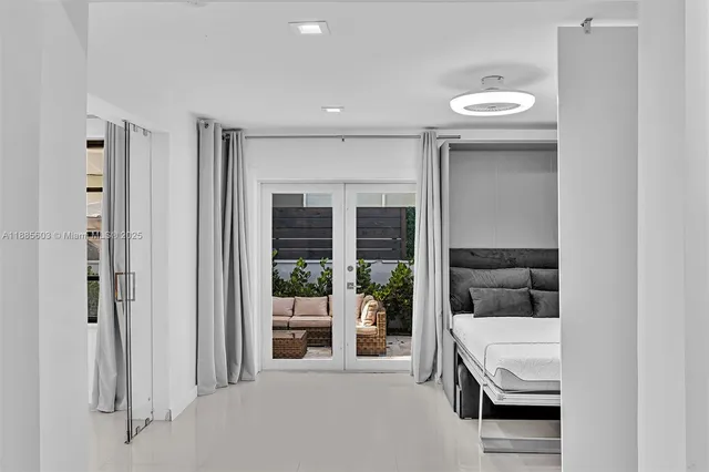 a bedroom with a bed and glass door