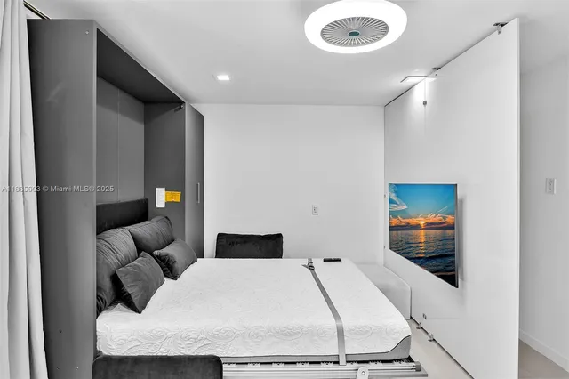 a living room with furniture and a floor to ceiling window